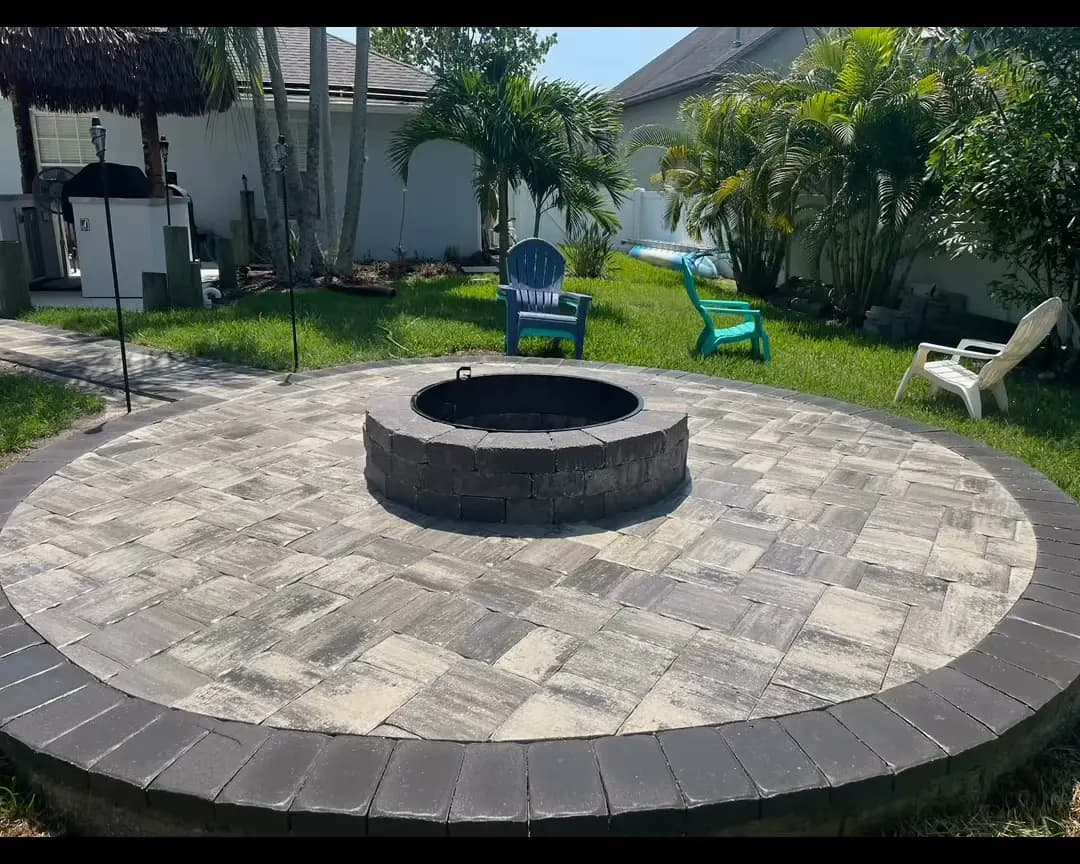Backyard paver patio with a round fire pit area in Central Florida