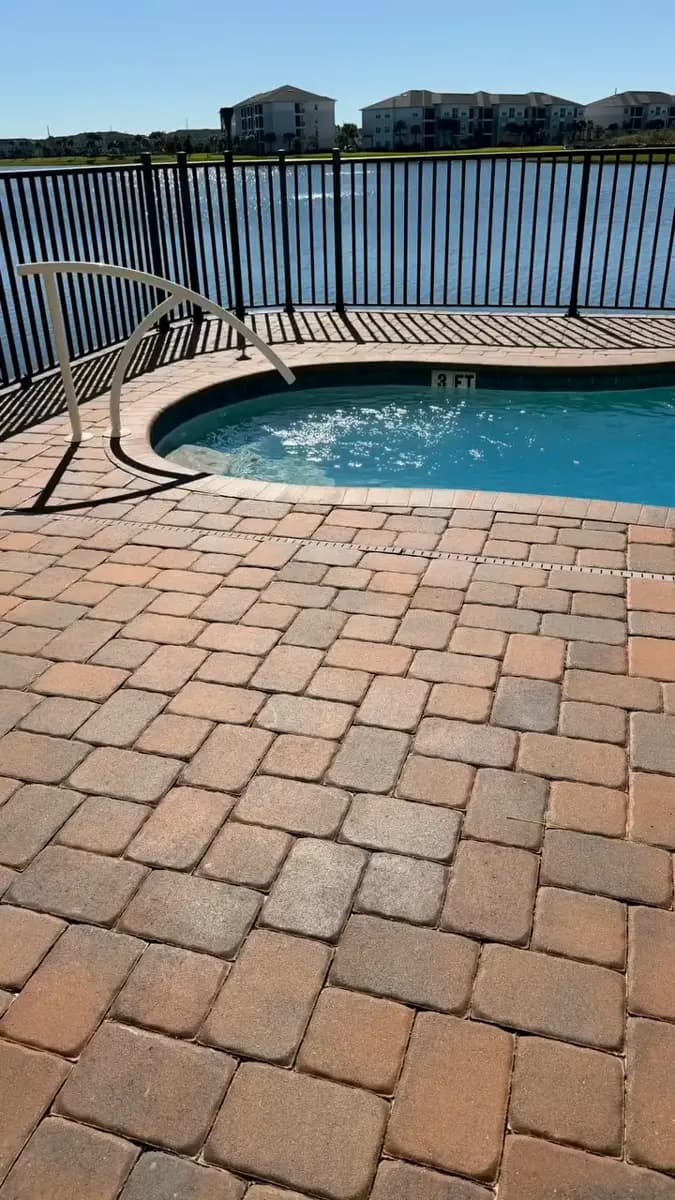 Freshly sealed paver pool deck at a Central Florida home
